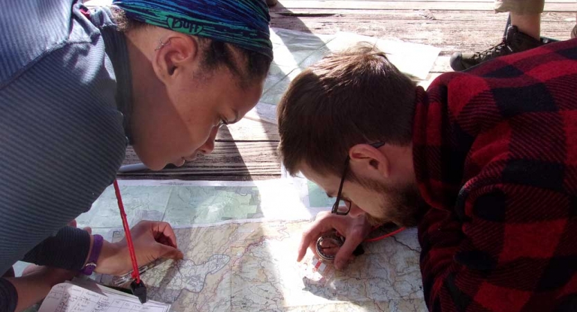 two people study a map 